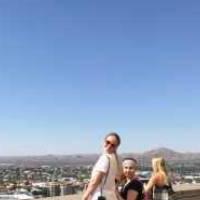 Students posing by a roof ledge